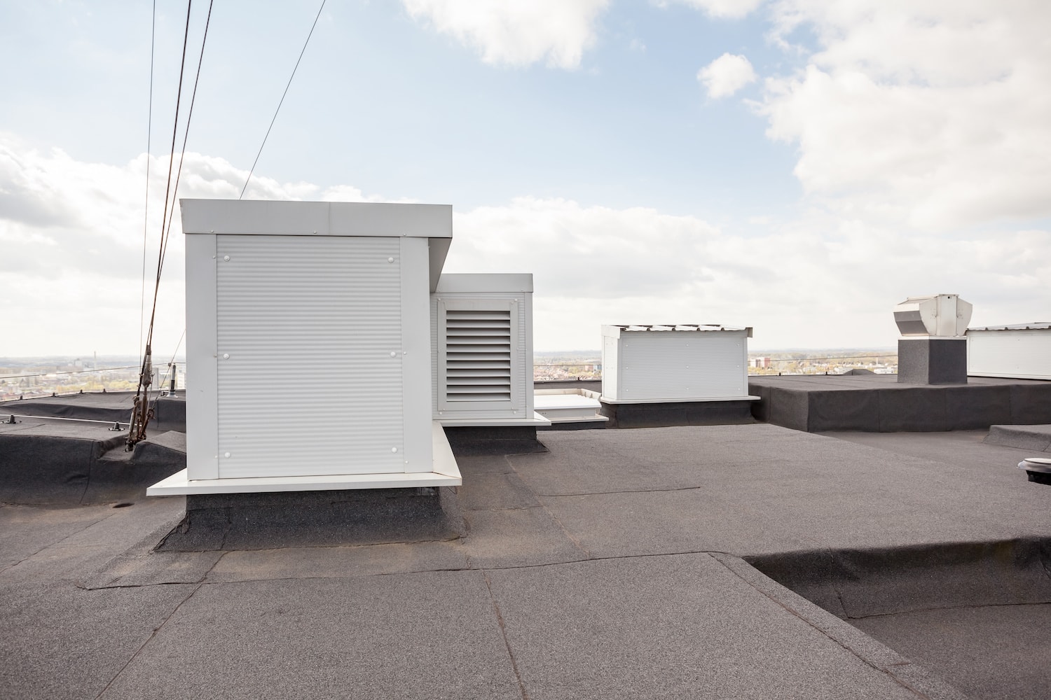 Beavercreek Commercial Roofing flat roof with white vents