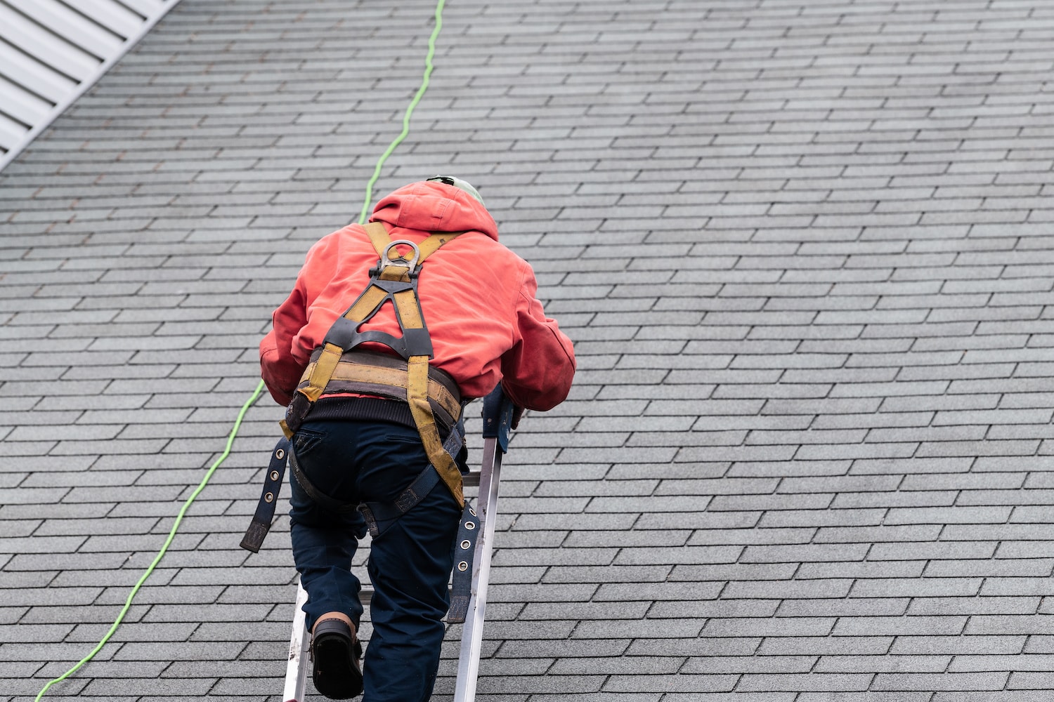 roofer performing a wind damage inspection