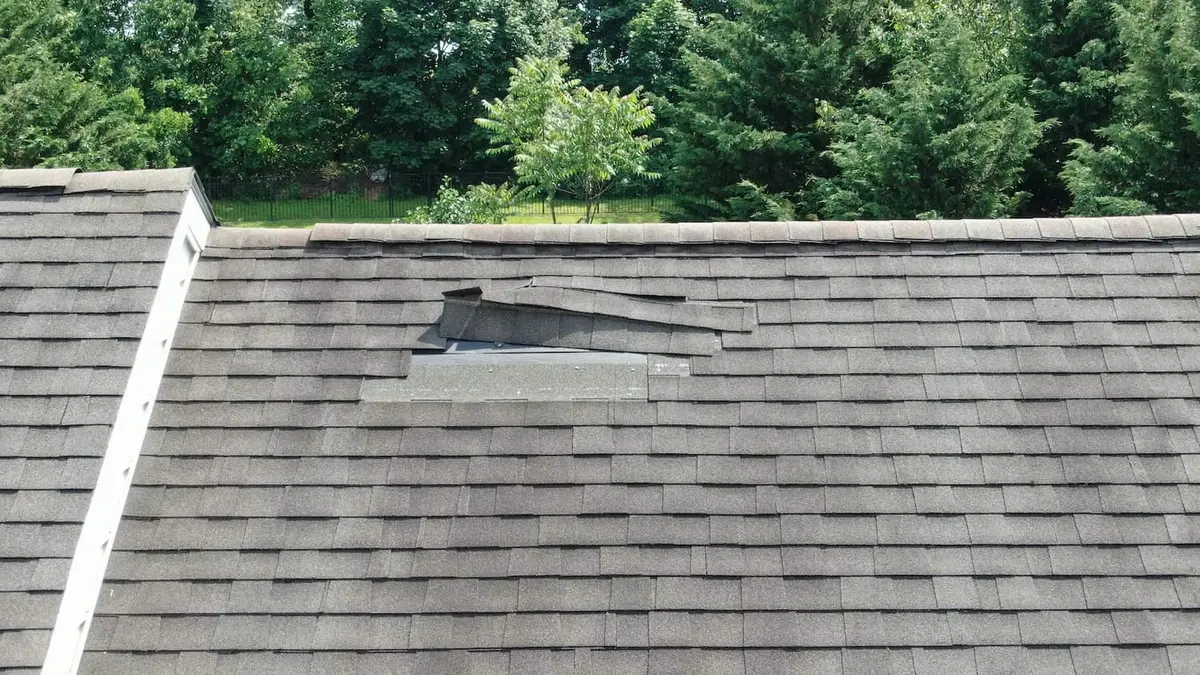 folded up shingles that have sustained wind damage