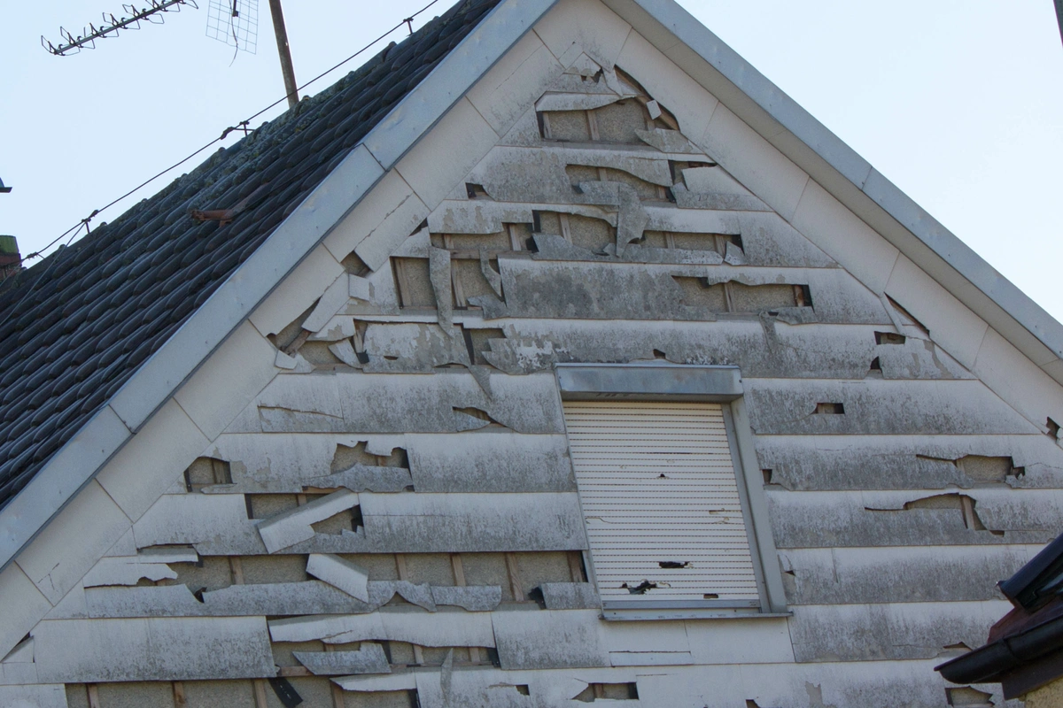 damage on house siding after hail storm