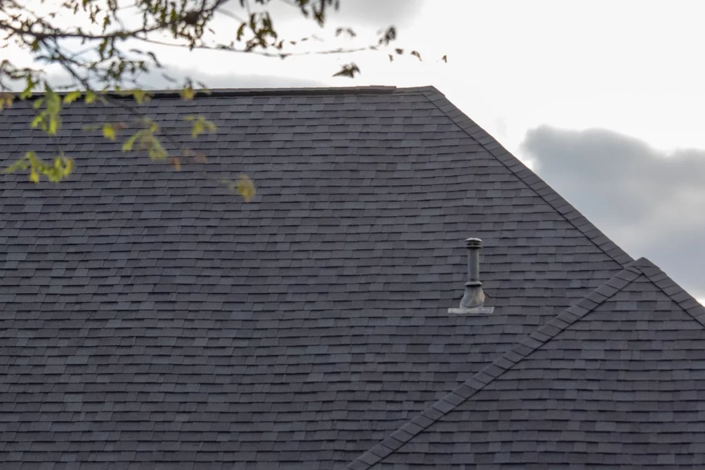 vent on the large house roof with asphalt shingles
