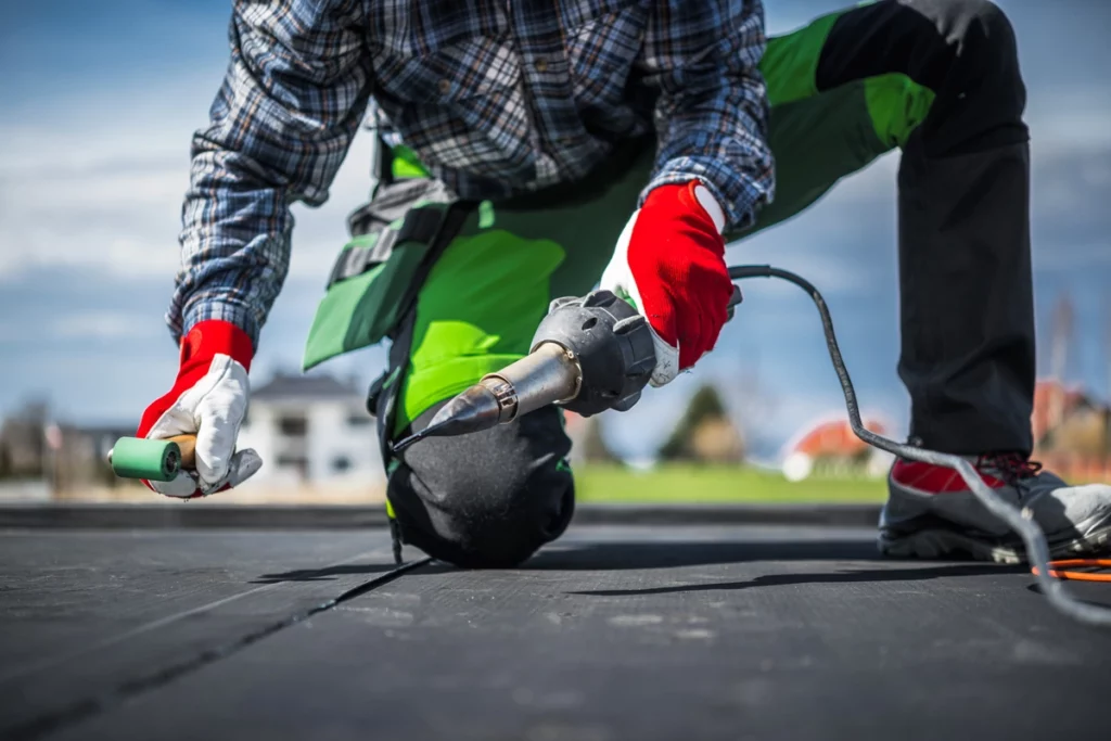 a roofer installs epdm rubber roofing