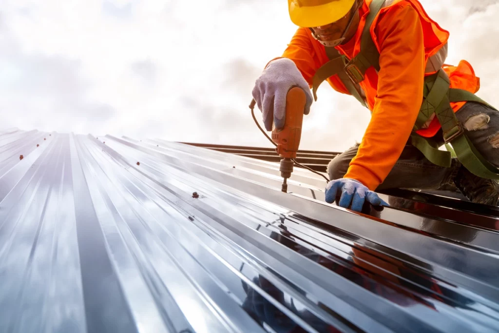 a roofer installs a metal roof