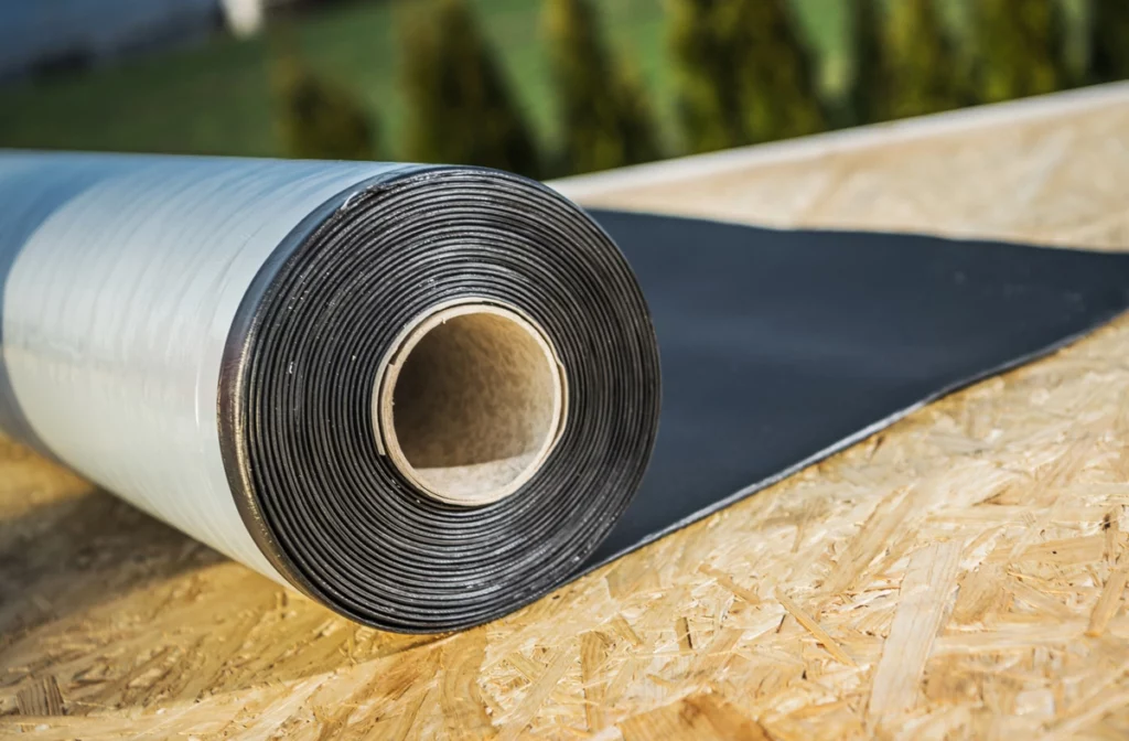 a roll of rubber roofing on plywood roof deck