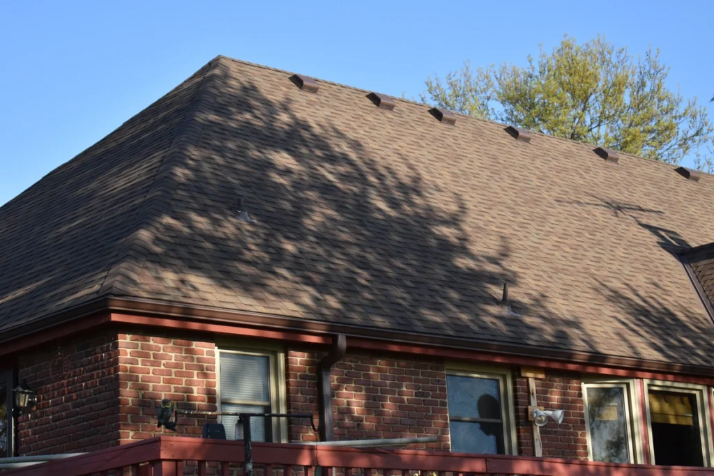 A brick house with a steep tile roof