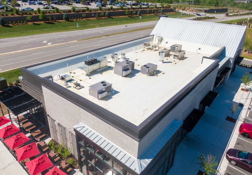 Drone Images of TPO Flat Commercial Roof With Metal Panels: