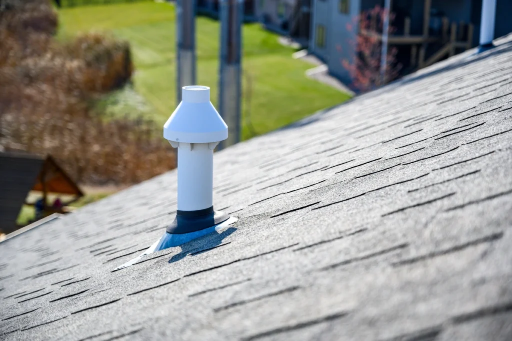 white roof boot on an asphalt shingle roof