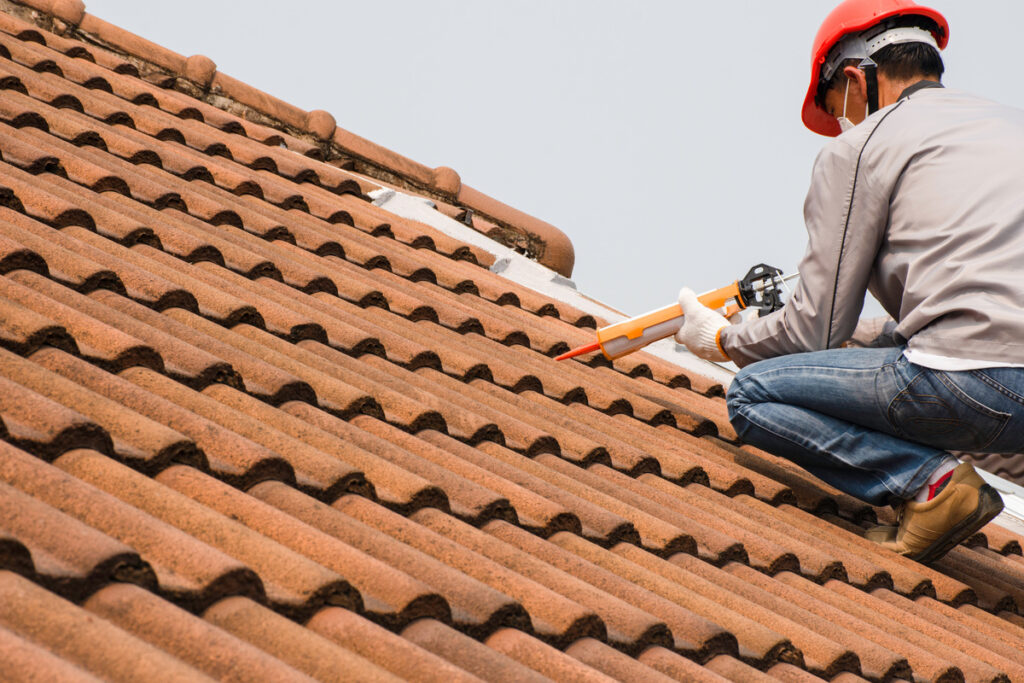 a worker is fixing roof leakage