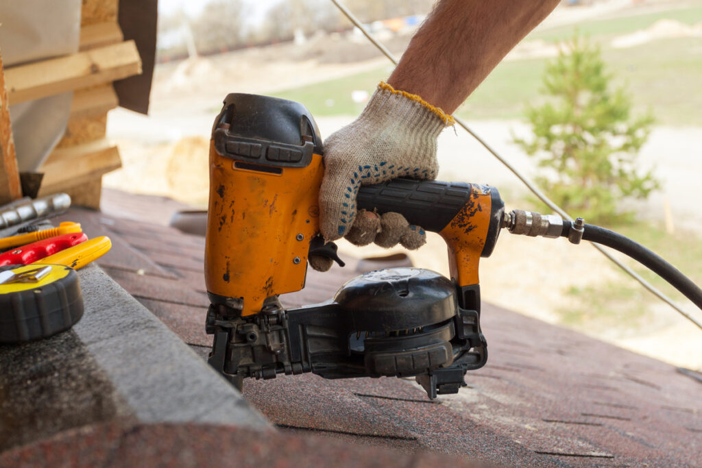a worker is using nail gun