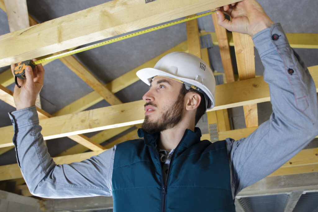 a roof installer measuring roof