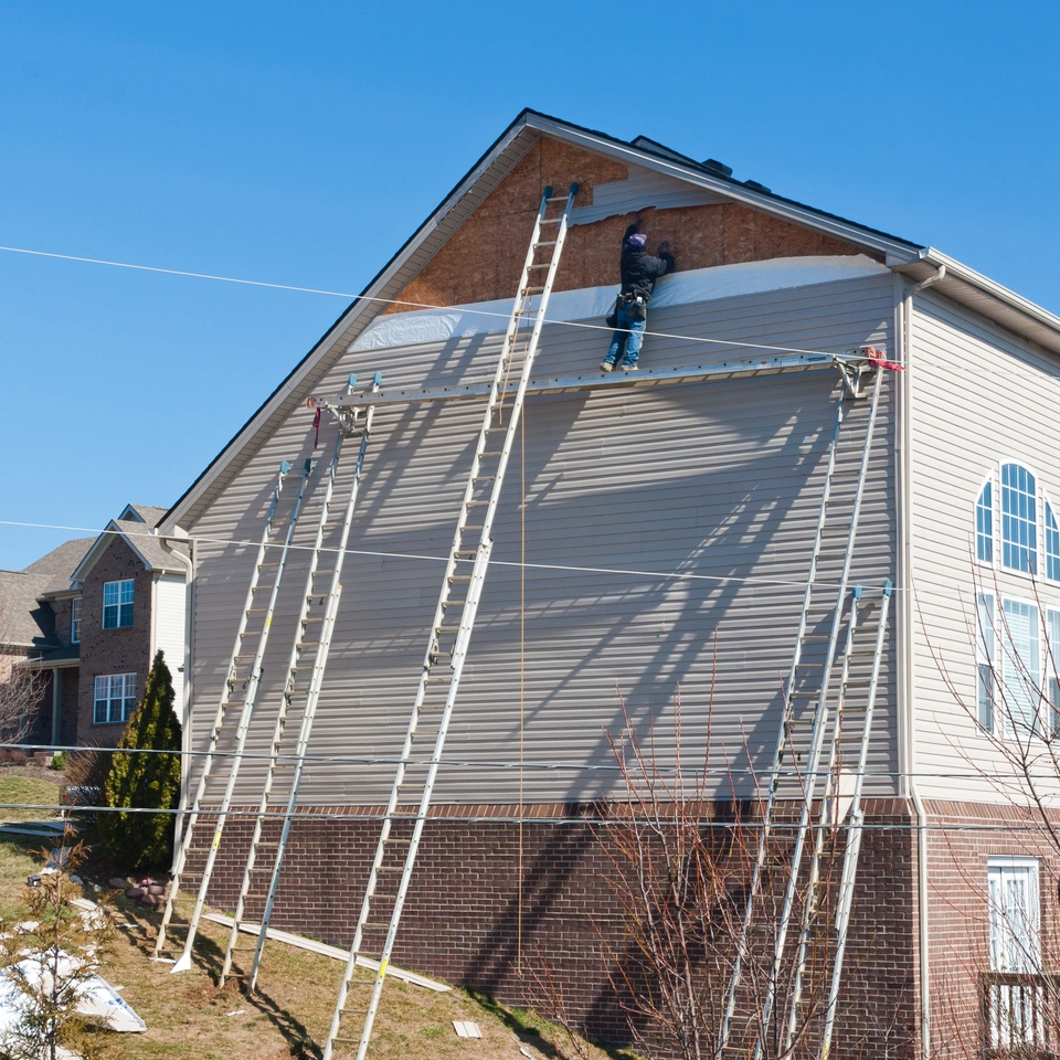 Installing siding on the side of the house
