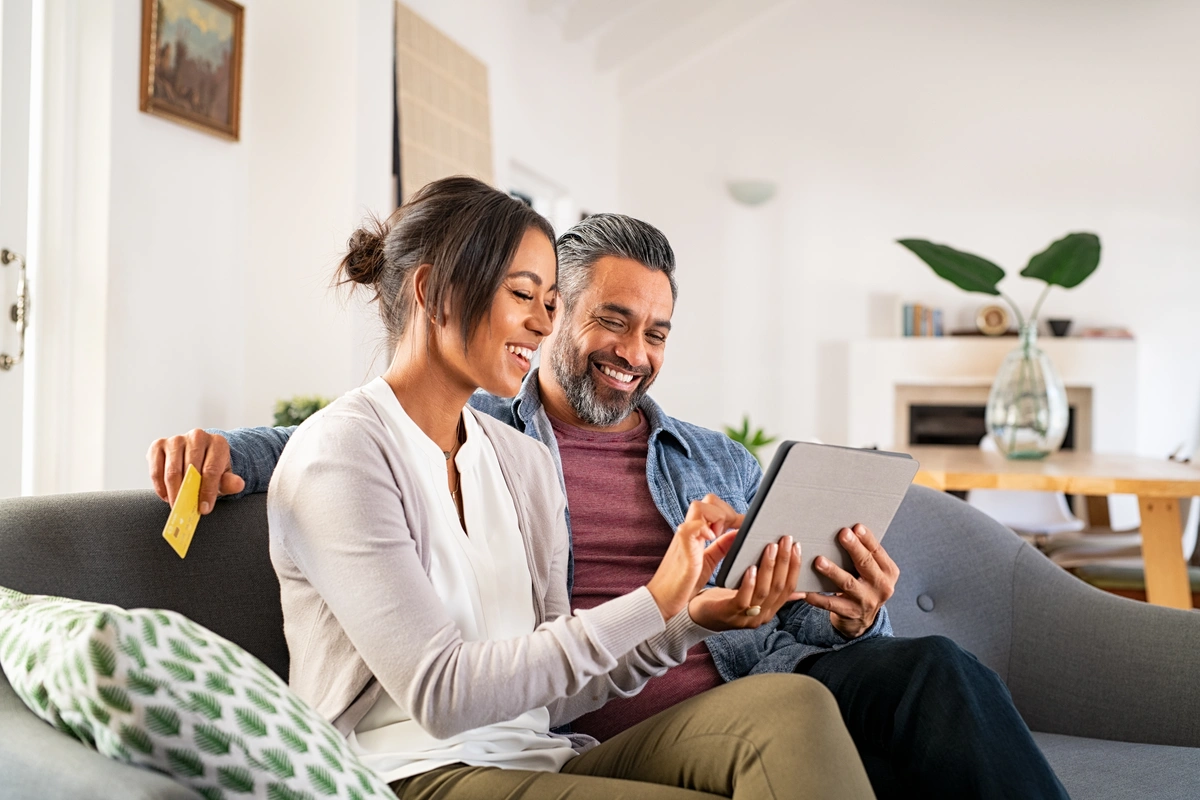 couple sitting on the couch with a laptop -vandalia oh