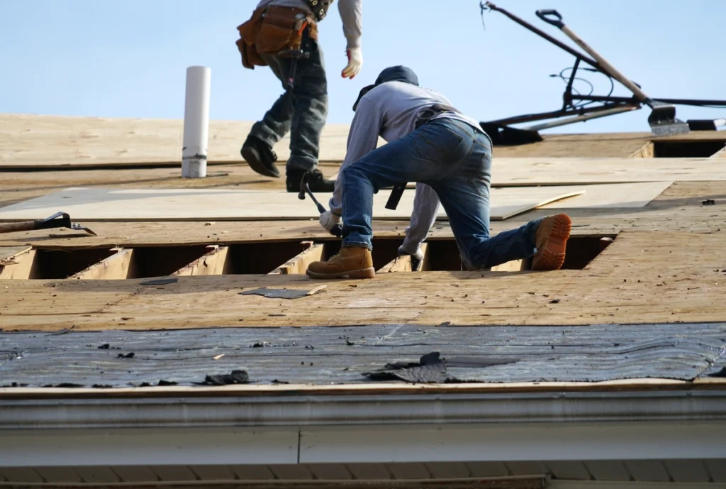 two men on a roof fixing a major leak