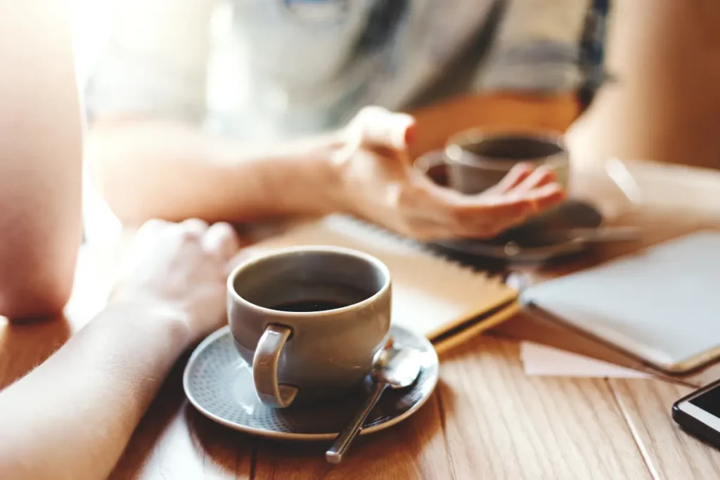 sharing cups of coffee