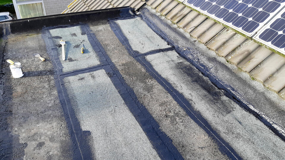 flat roof repair-flat roof with sections patched