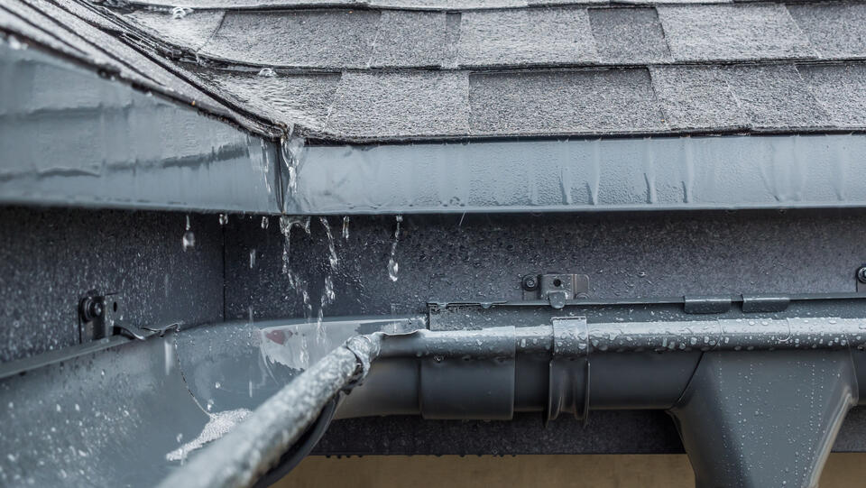 gutter colors-silver metallic gutters on home roof catching rain water