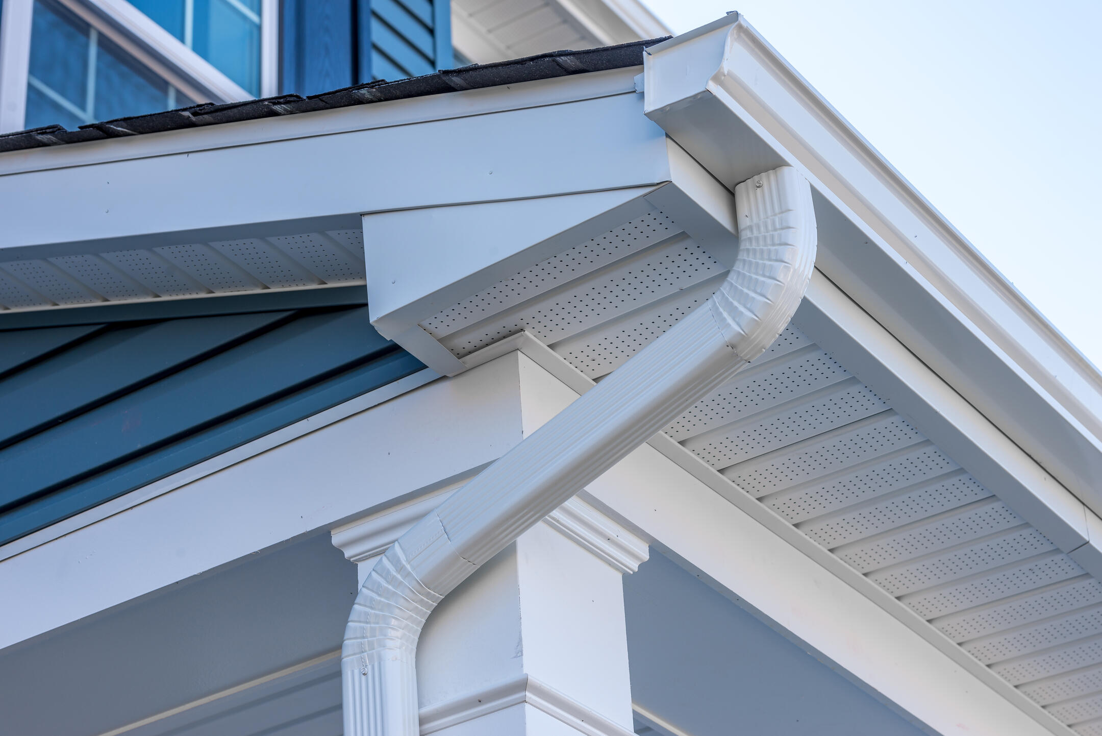 gutter colors-white gutter system on blue sided house
