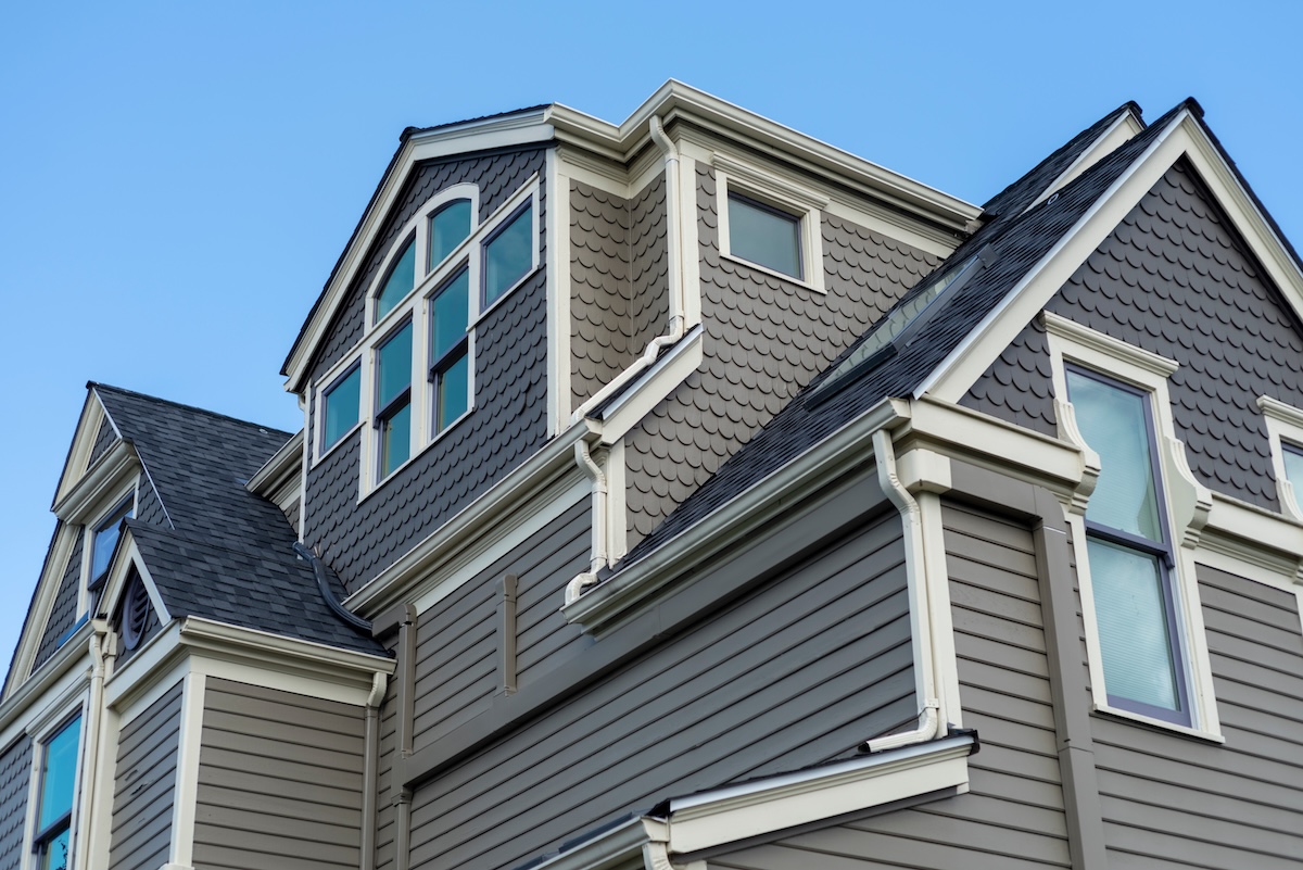 large historic home with gray siding