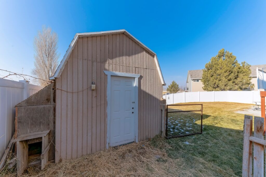 Shed with gambrel roof and white door 
