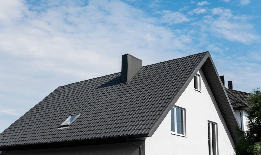 Modern black metal roof on white house