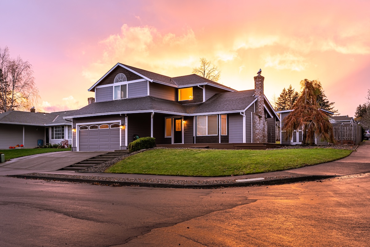 sunset behind residential house with new siding