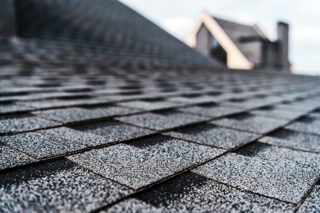selective focus of grey shingles on rooftop of house