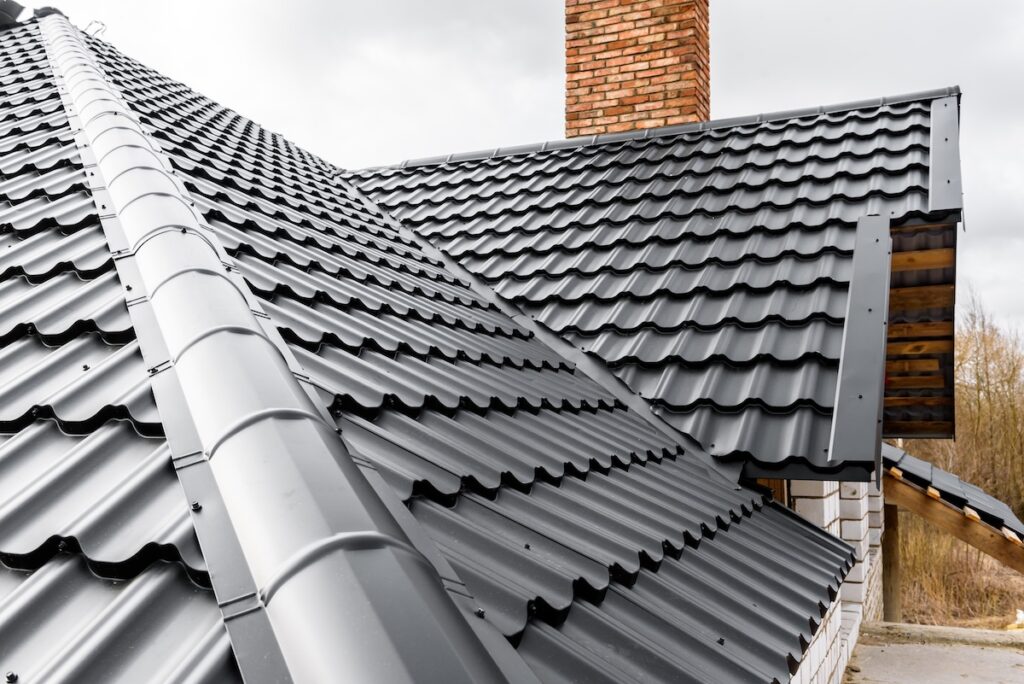 black metal roofing shingles installed on large home