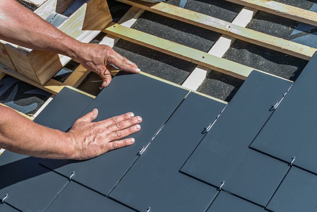 Craftsmen are installing a slate roof