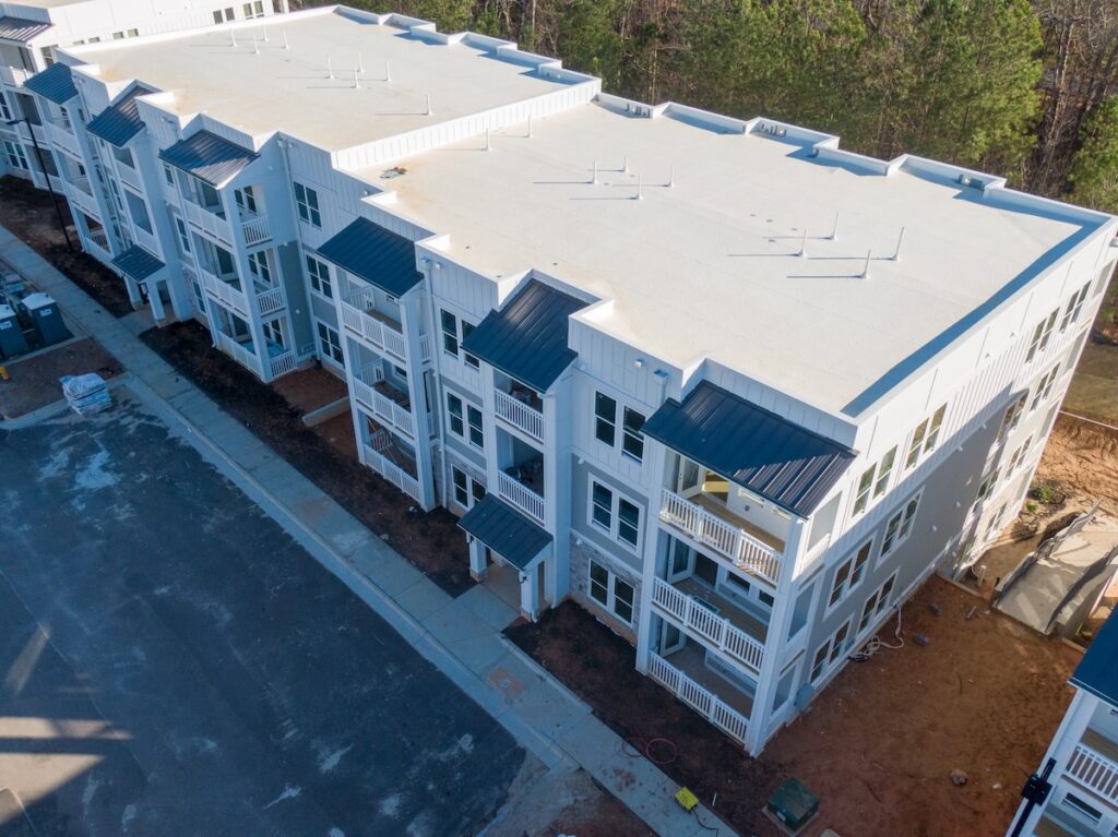Drone photo of the top of an apartment building with PTO roofing installed