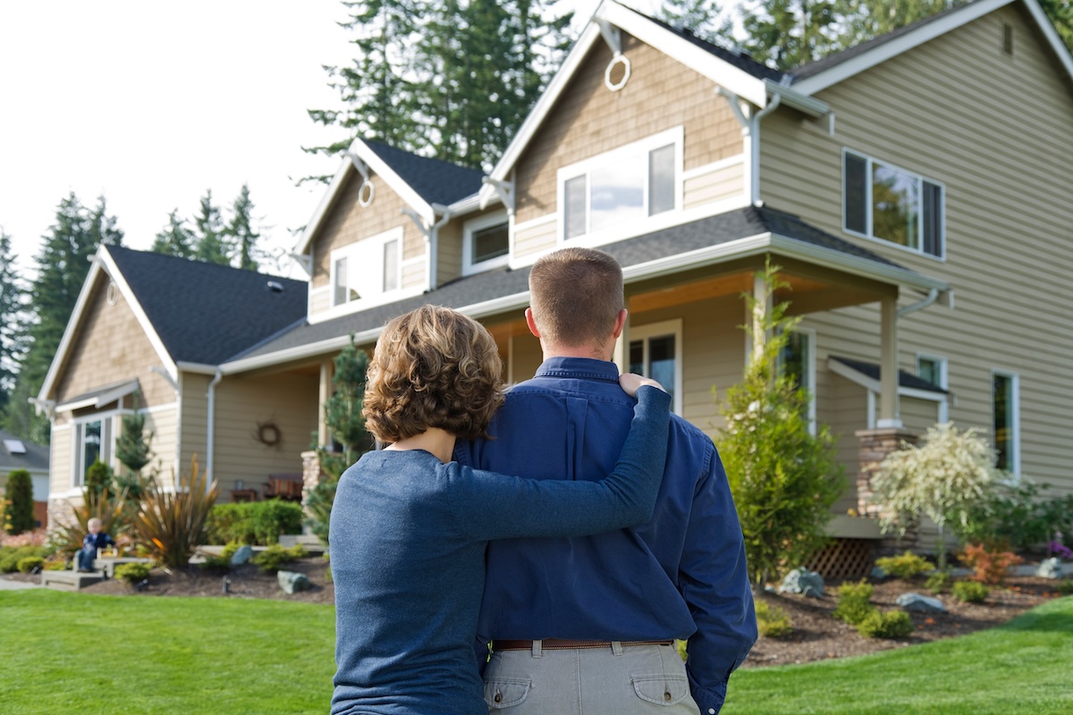 Couple looking at the exterior of their new house