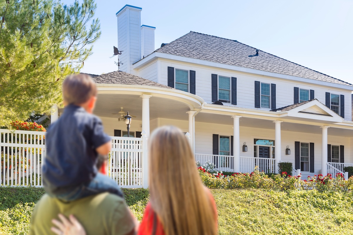 Family Looking At Beautiful New Home.