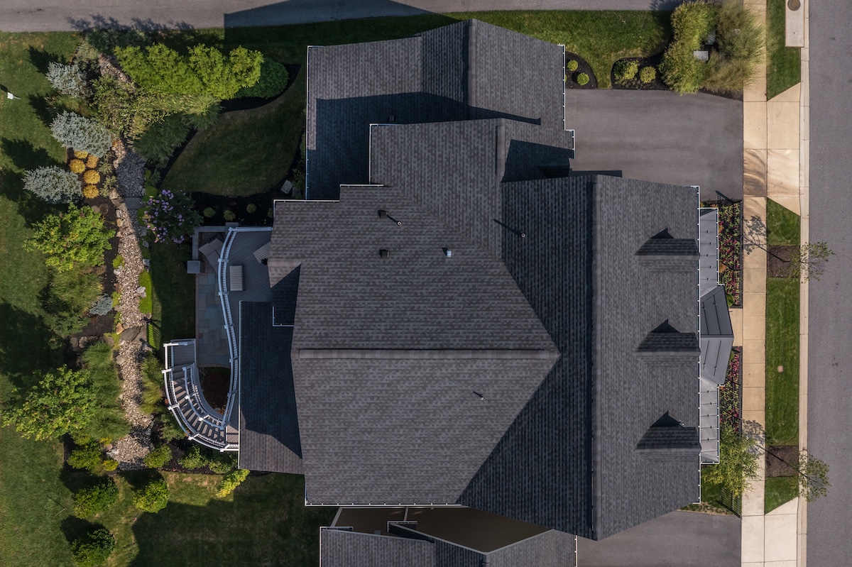 Aerial top down view of a complex hip and valley pitched roof with three dormers