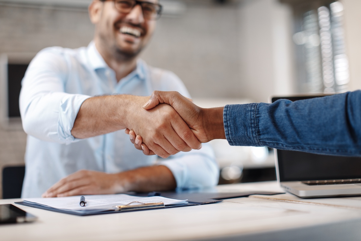 Close up of handshake in an office
