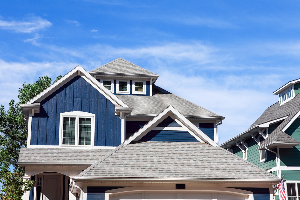 Dark blue house with light gray shingle roof