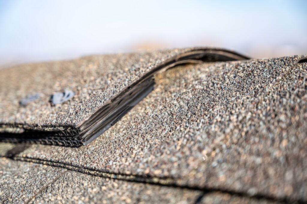 Typical residential ridge cap on a shingle roof apex