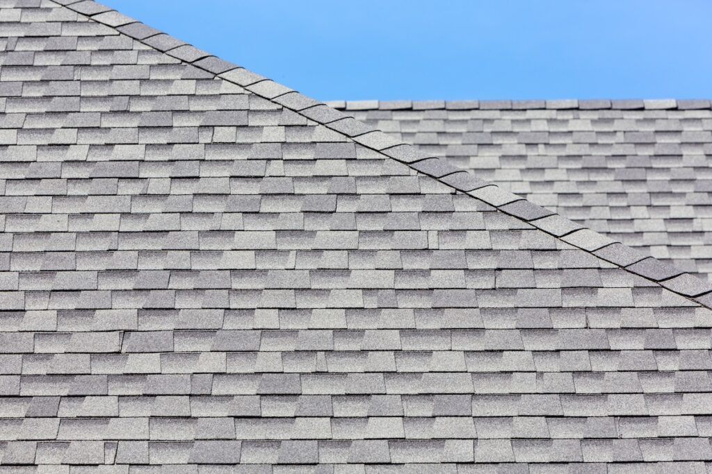 Close up of new rubber roof tiles with blue skybackground.
