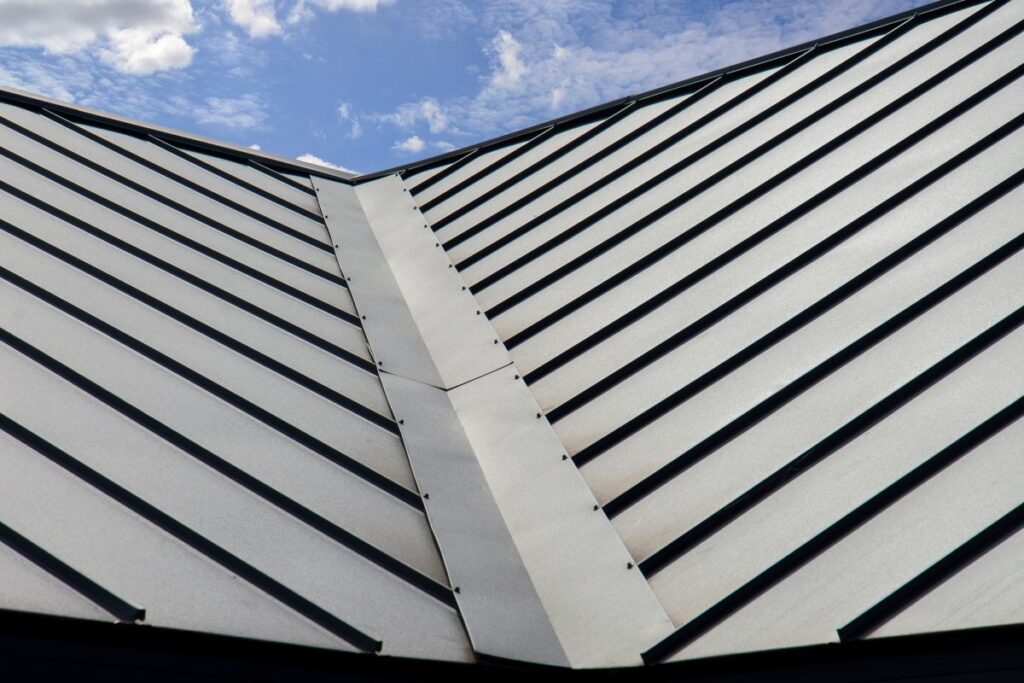 Standing seam metal roofing system on sky background