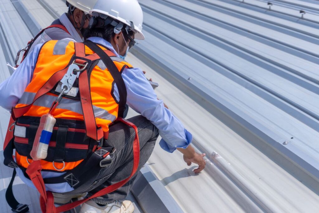men measuring a metal roof