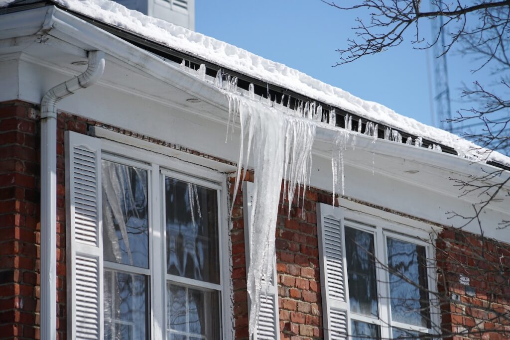 icicle on the house roof in winter season