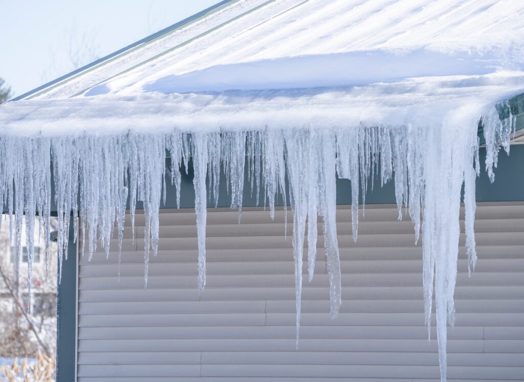 metal roof with icicle and snow and ice dams