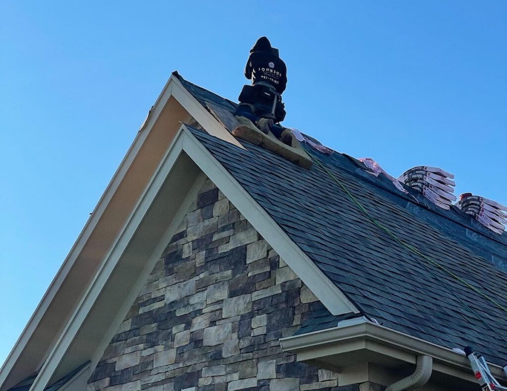 Johnson restoration worker on gable roof