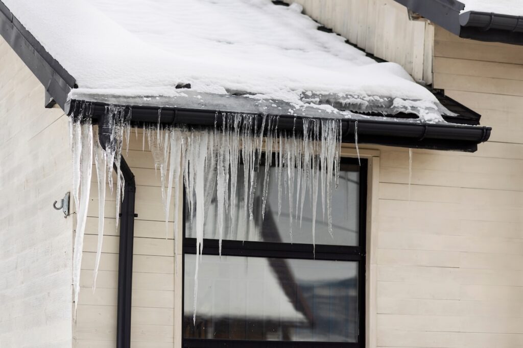   Ice Dams from Roof Gutter of House Home  