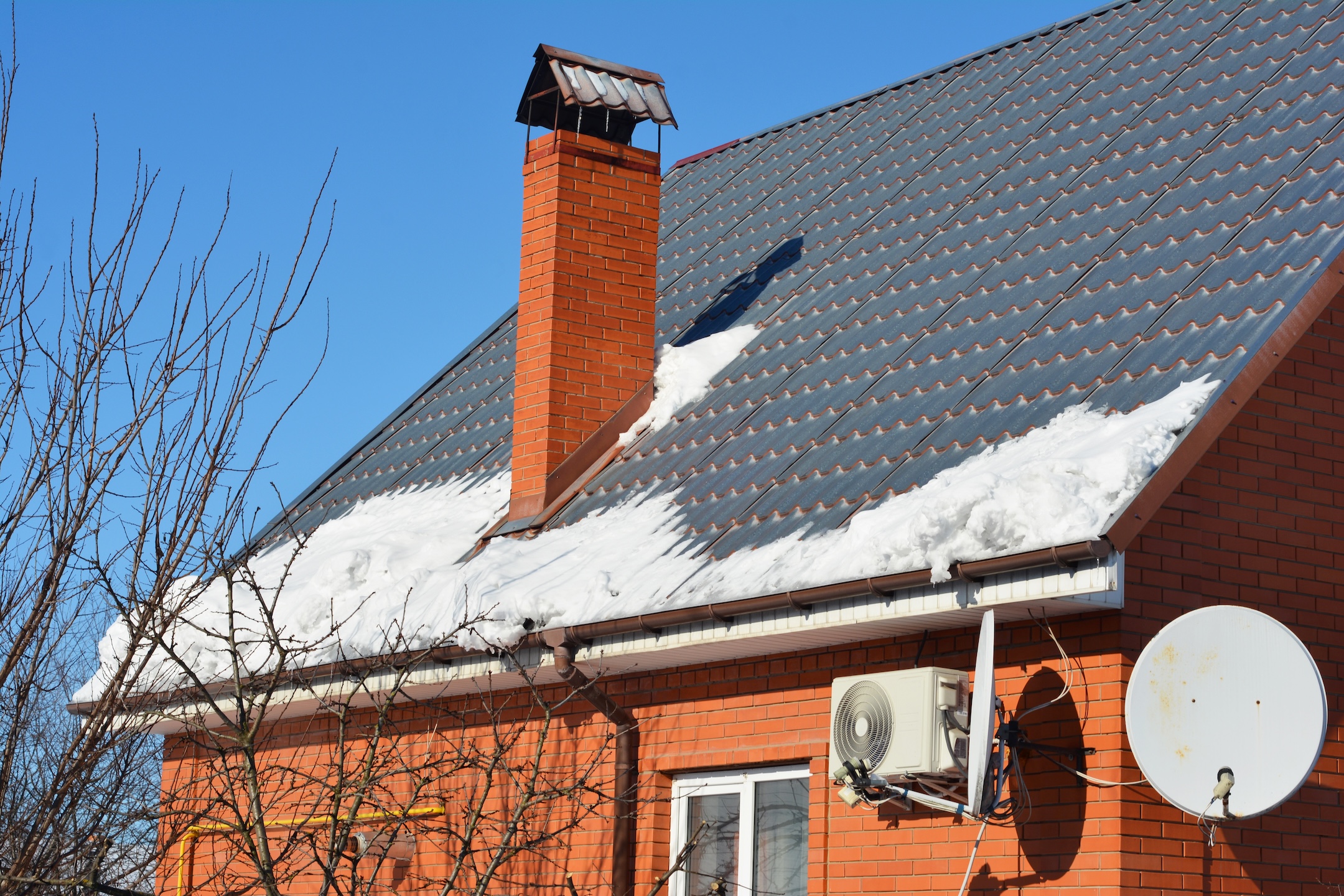 Melting Snow on House Roof Threatens Gutter
