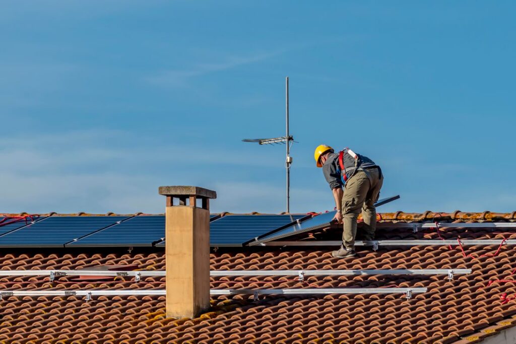 solar shingles vs solar panels ceramic tiles worker installing panels