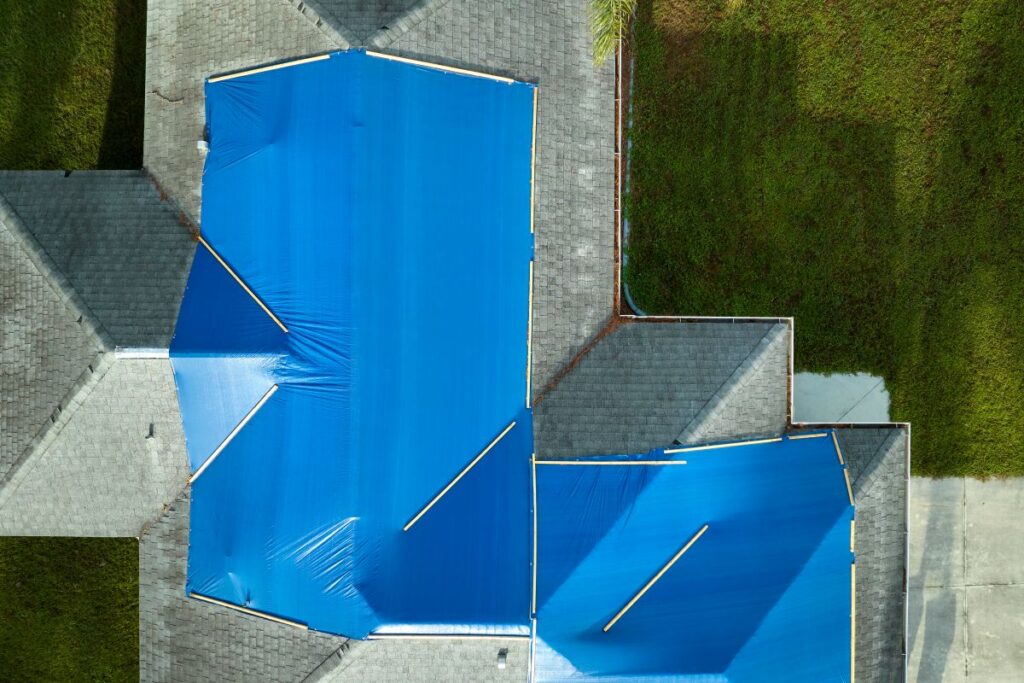 roof tarping blue tarp on top of roof
