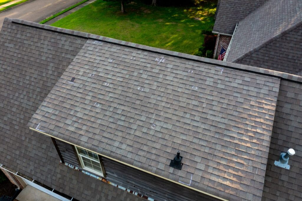 how to check for roof damage after a storm hail affected shingles roof marked
