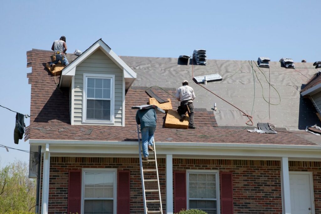 roof tarping workers repairing roof after storm