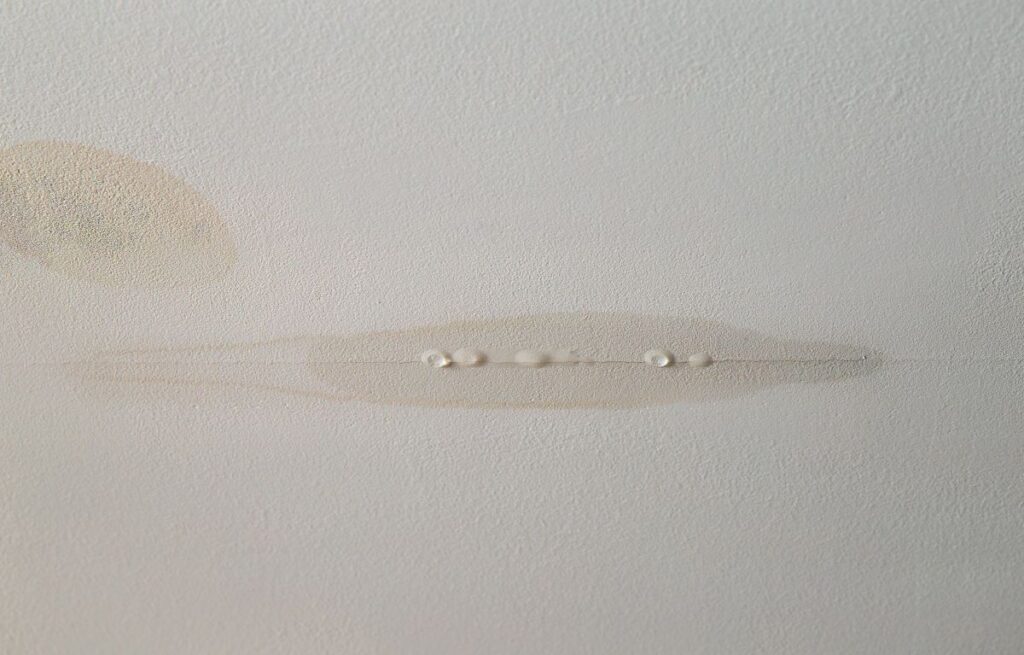 ceiling water damage repair drops on wall