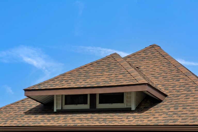 how long do asphalt shingles last brown roof blue sky