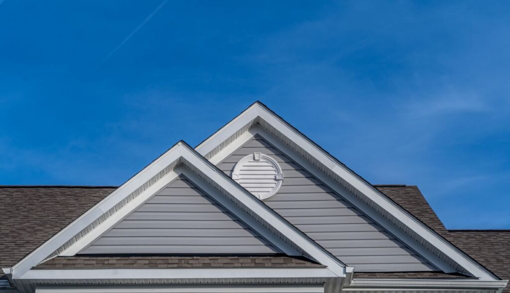pitched roof dark grey shingles blue sky
